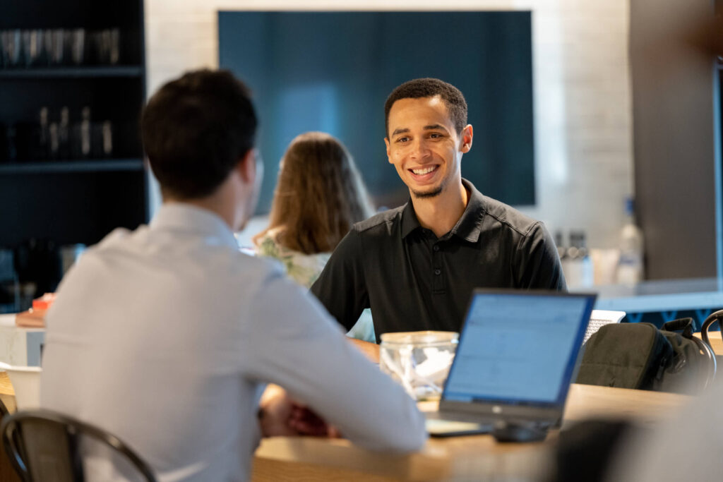 Two professionals at Turnberry meet in coworking space at Turnberry's modern office