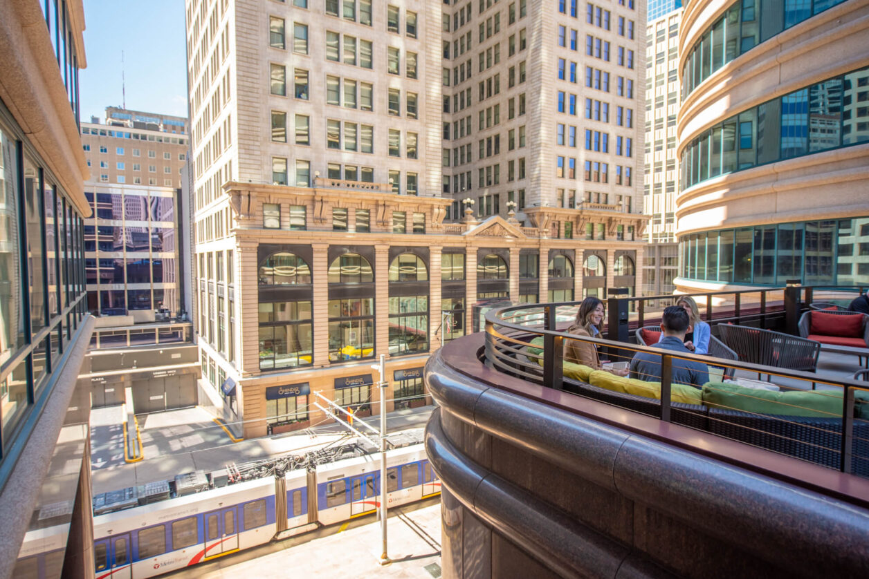 Turnberry professionals meet outside on Turnberry's rooftop terrace meeting space