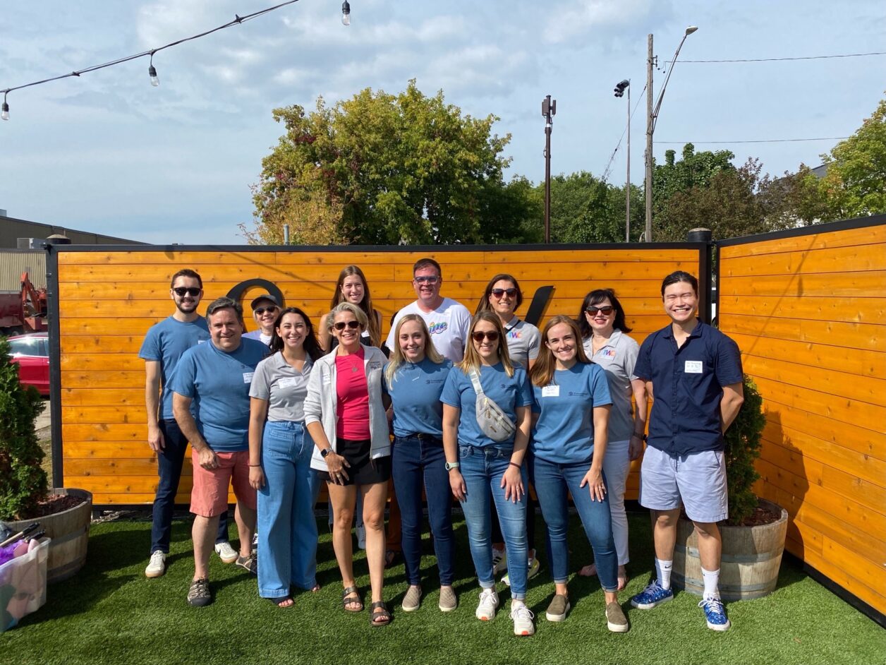 A group of Turnberry employees power for a photo at a social event