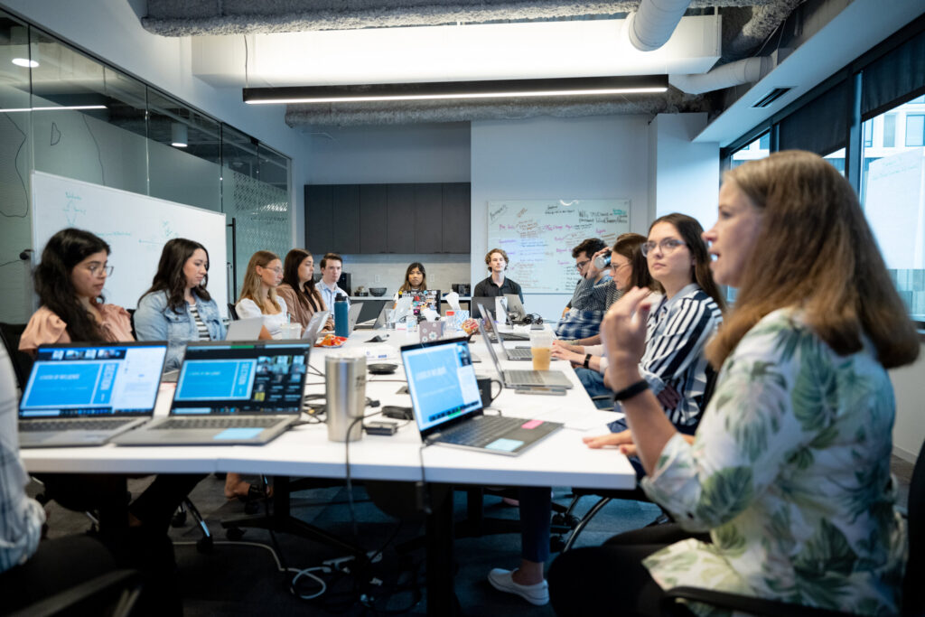 Several Turnberry colleagues meet in a conference room for a presentation and work session at Turnberry's modern Minneapolis offices