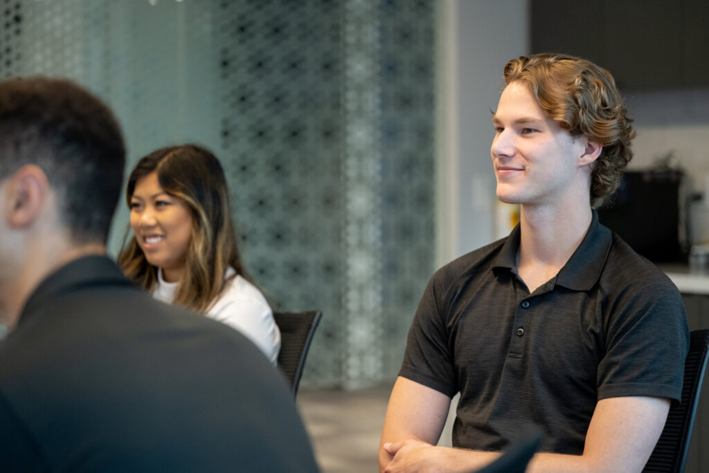 Turnberry professionals listen to a presentation at Turnberry's modern offices in Minneapolis, Minnesota