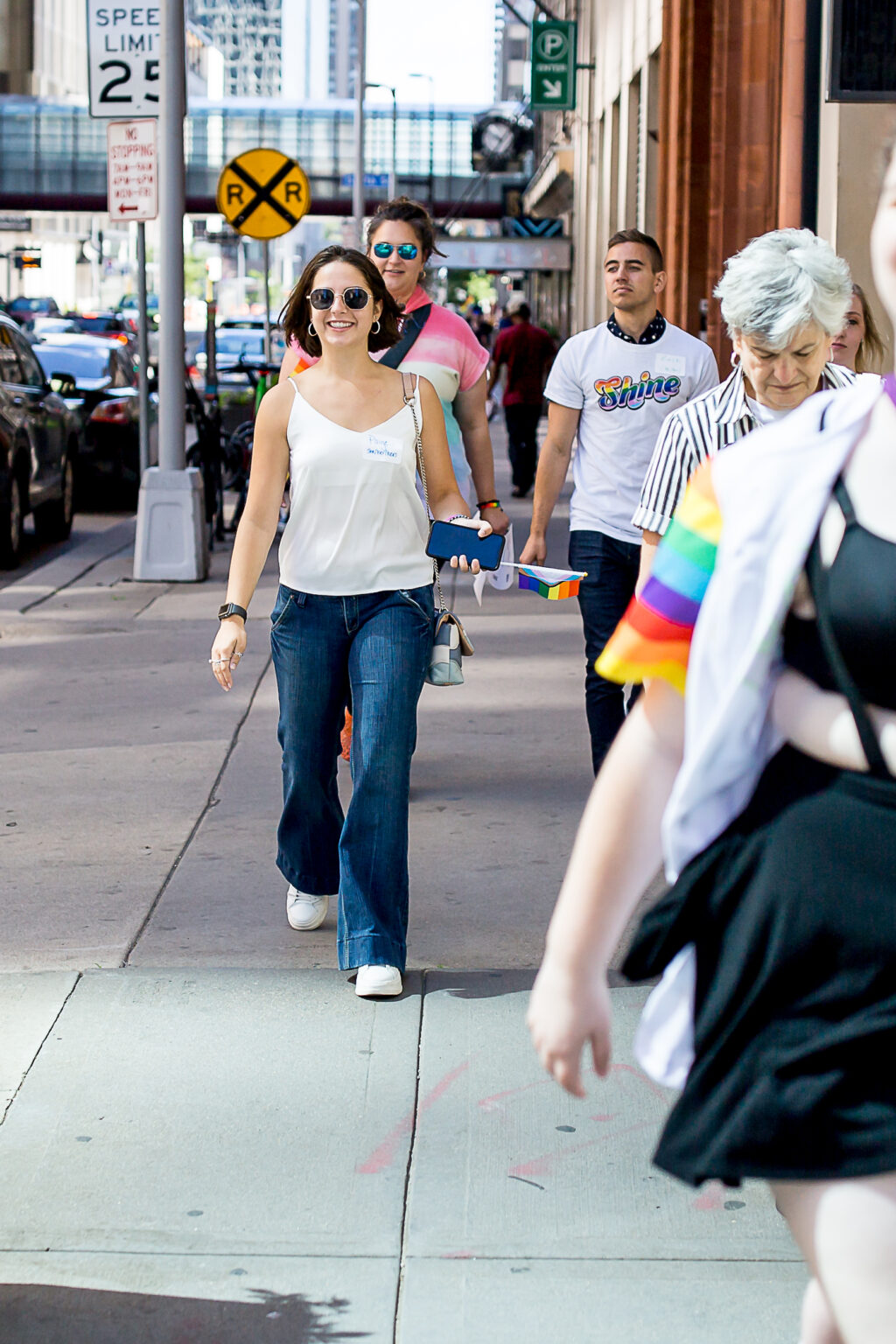 Men and women walking down the street in downtown Minneapolis weating Turnberry Pride attire